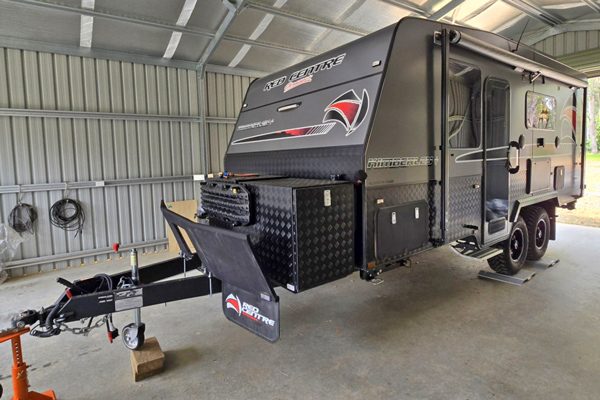 Caravan being weighed in a shed on mobile weighing pads