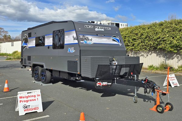 Caravan on wireless weighing pads with a Get Weighed sign